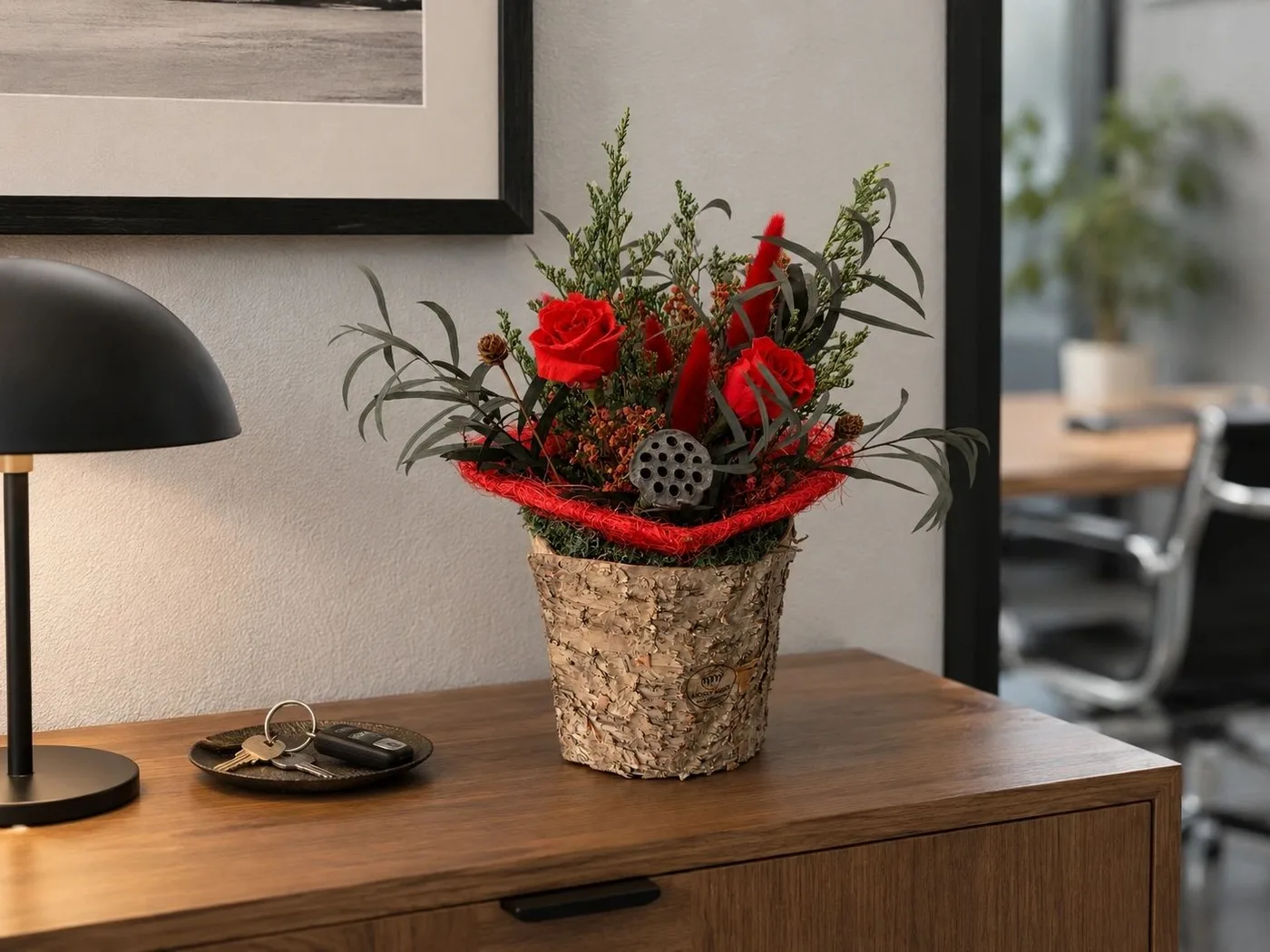 Red preserved floral arrangement on an office desk from the published gallery